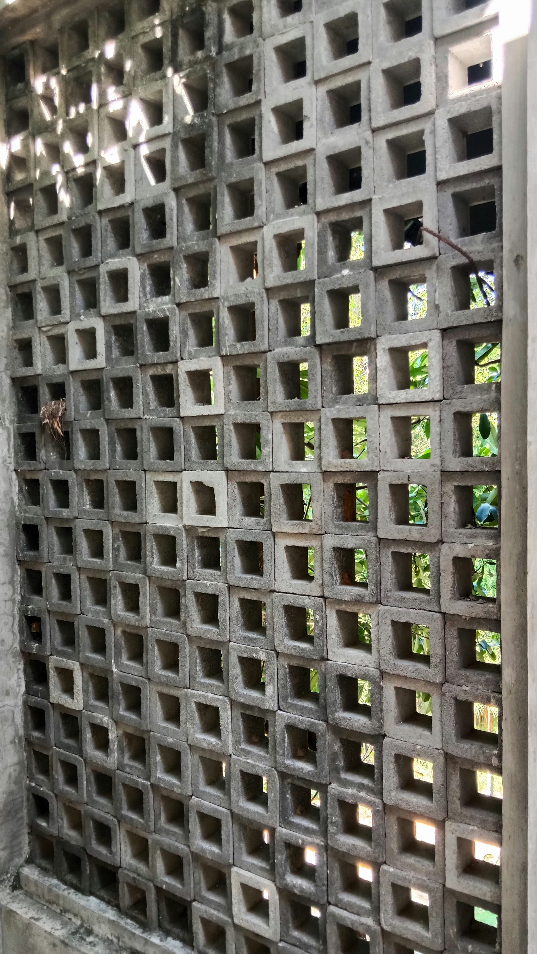 Modern building façade with decorative concrete ventilation blocks visibly integrated into the architecture