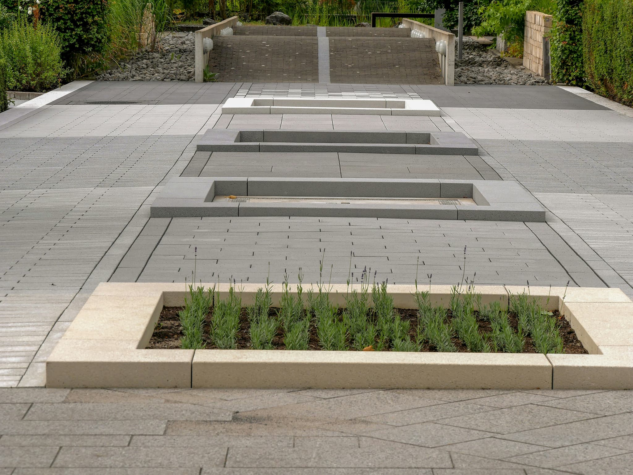 Concrete flower pots and outdoor seating in a landscaped garden