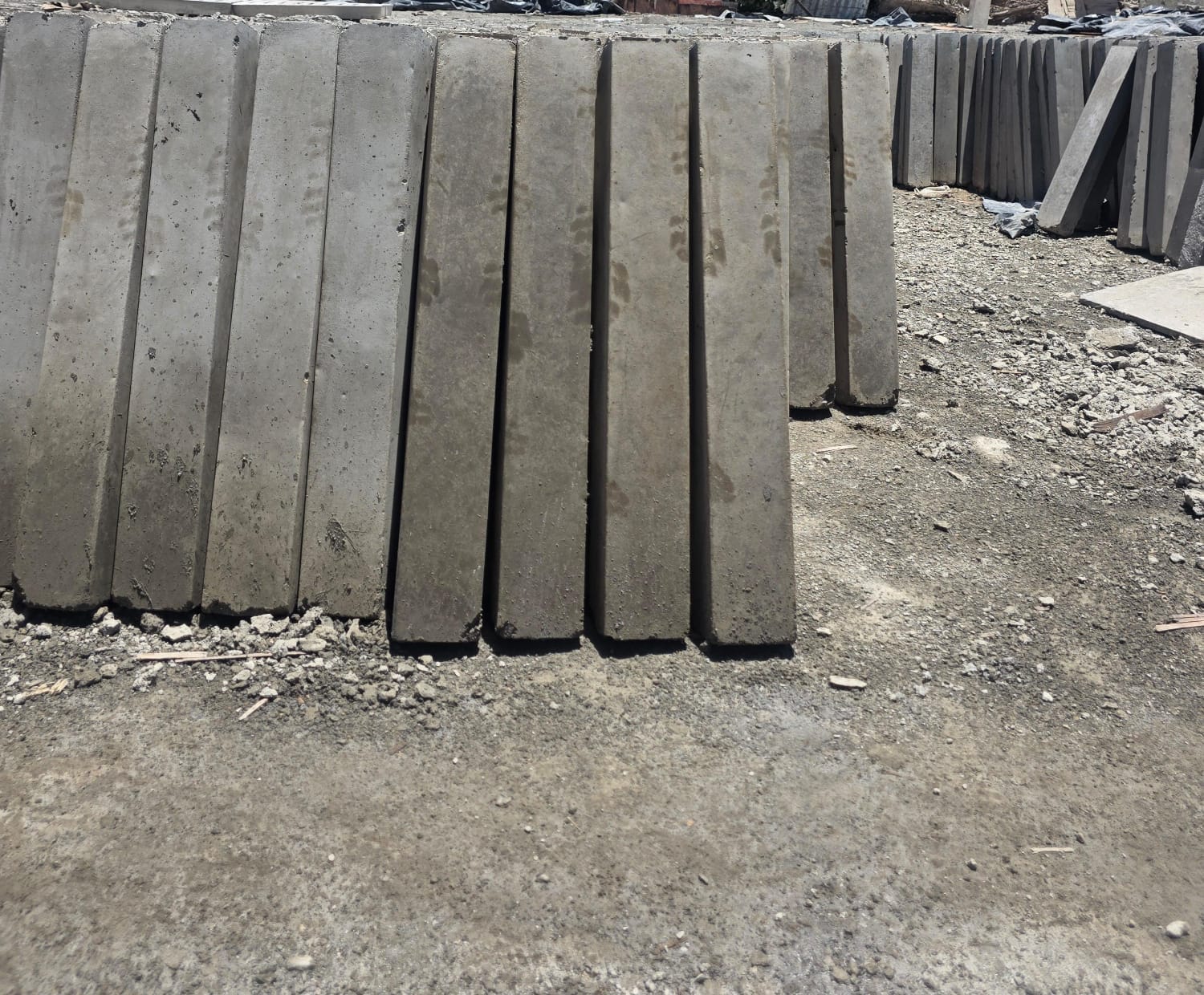UCB precast concrete road kerbs standing upright in a row at the Unique Concrete Blocks yard — road edging and curbing products in Kenya