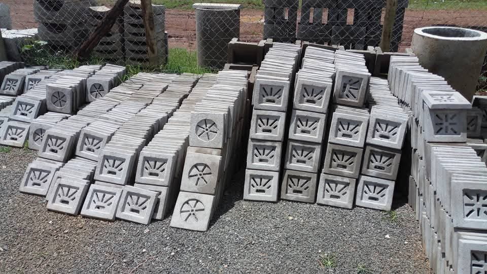 UCB netted concrete ventilation blocks — decorative perforated vent blocks with circular and sunburst cutout patterns at the Unique Concrete Builders yard in Kenya