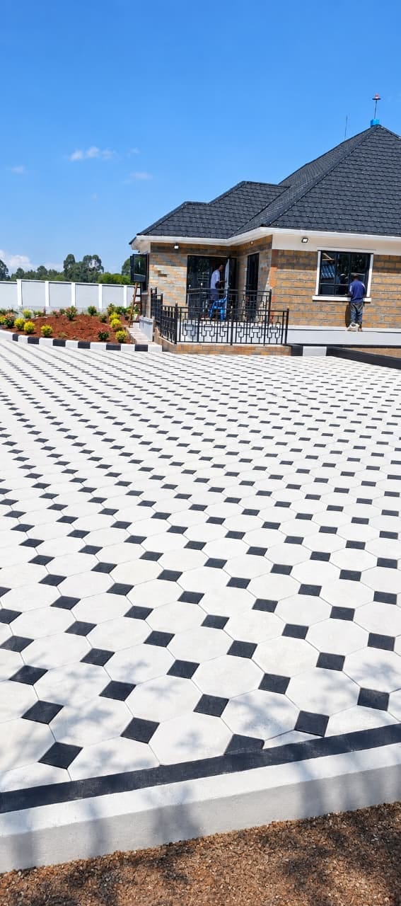 UCB Octagon Cabro Pavers installed on a premium residential driveway — white octagon pavers with black square inserts beside a modern clay-tile roof house in Kenya by Unique Concrete Builders