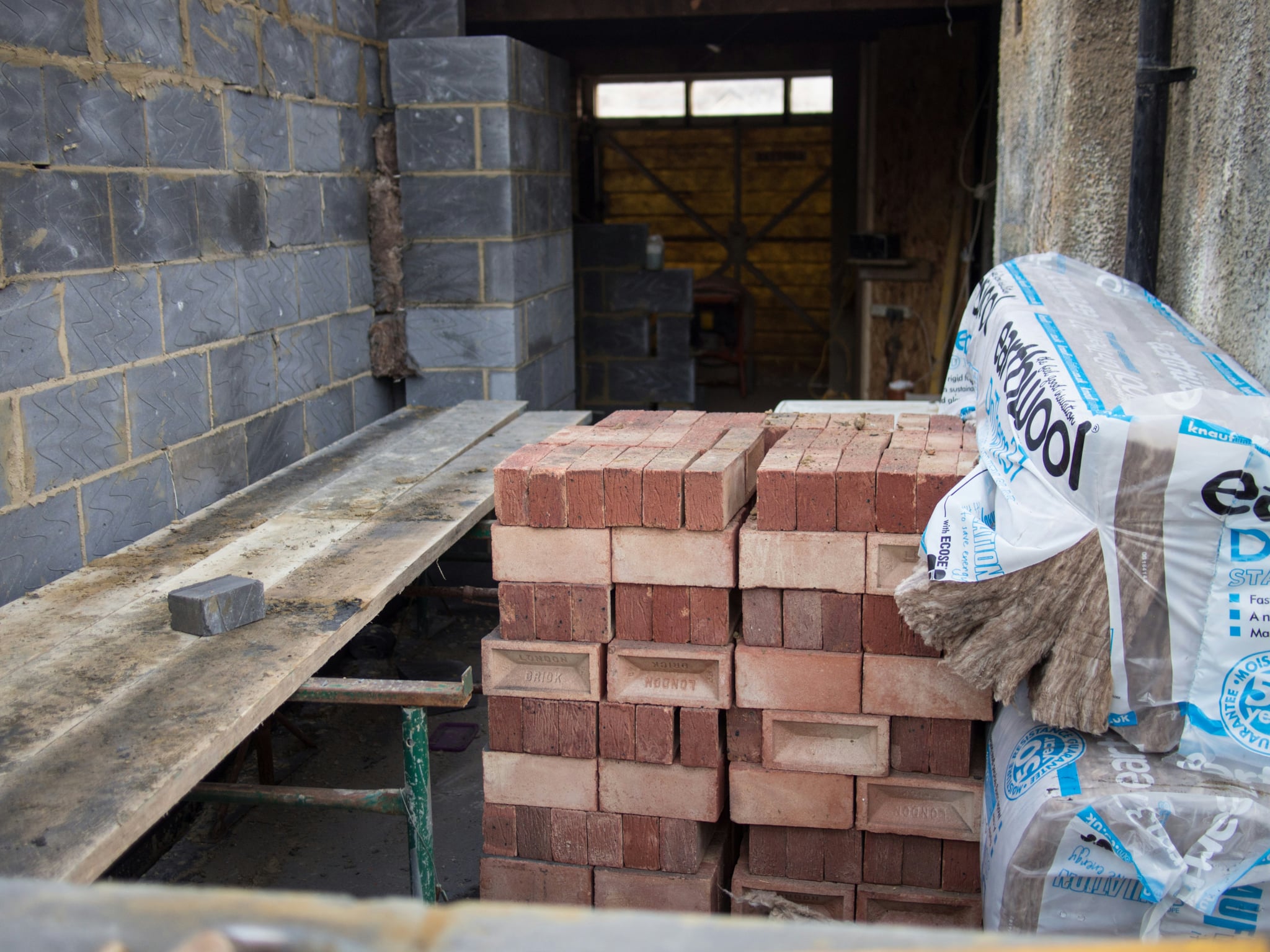 UCB Standard Bricks stacked at a construction site by Unique Concrete Builders Kenya