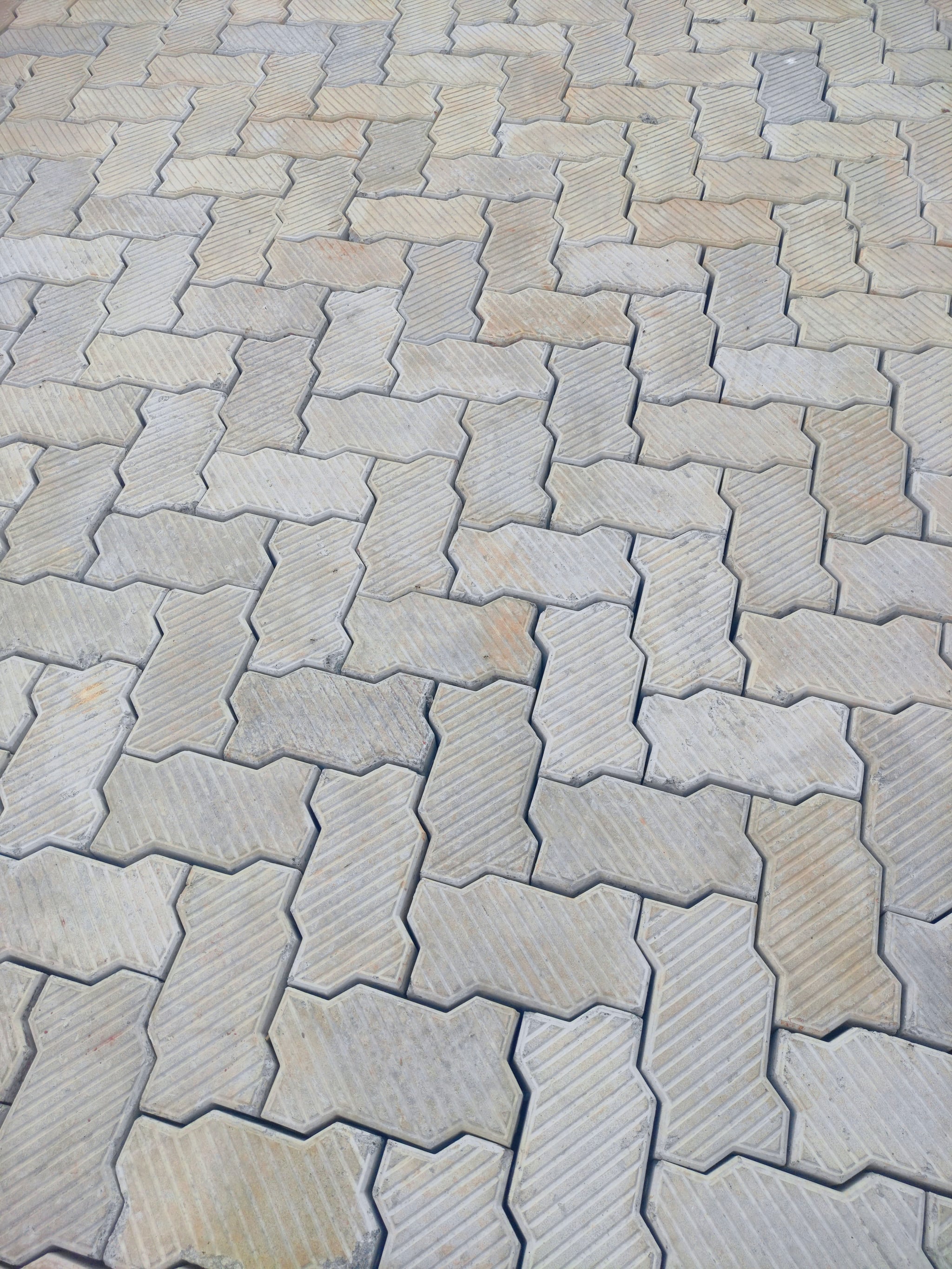 UCB Dune Pavers creating a wave pattern in a garden path by Unique Concrete Builders Kenya